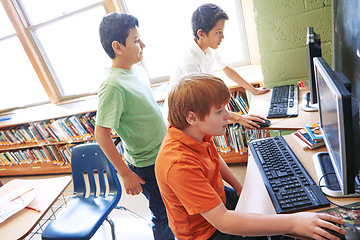 Image showing Children, education or kids in classroom with computer for learning, research or website search. Scholarship, thinking or students happy in school library for social network, academy or assessment