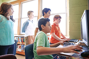 Image showing Diversity, education or children in classroom on computer for learning, tech research or website search. Scholarship, thinking or students in school library for social network, academy or assessment