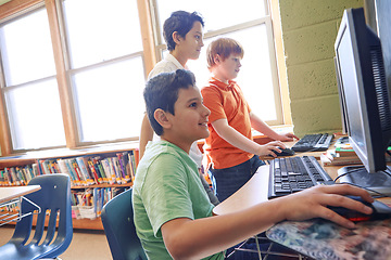 Image showing Learning, education and students on computer in classroom or middle school. Development, pc and group of boys or kids studying computers, information technology and software, coding or programming.