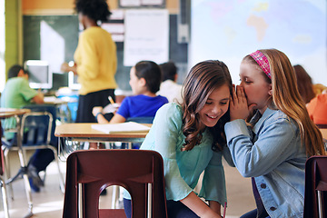 Image showing Friends, whisper and gossip in classroom for secret, talking or chatting during teaching lesson. Sneaky female learners sharing quiet information secretly in ear at class while teacher is busy