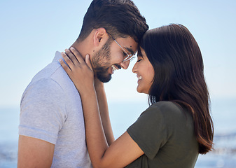 Image showing Love, couple and hug at beach with travel and care on summer holiday by the ocean, commitment and support outdoor. Young, happy and relationship with romantic date, man and woman profile on vacation