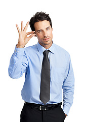 Image showing Portrait, gesture and small with a business man in studio isolated on a white background to sign a tiny symbol. Social media, review and feedback with a male employee posing on blank marketing space