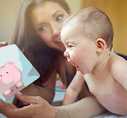 Image showing Mother, baby and family for learning, development and pig picture book for fun education and growth. Woman and child in house to bond and play with love, security and care with a smile and happiness