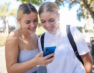 Image showing Smartphone, park and student friends on internet, social media post or website information search for university, campus or college. Youth women reading mobile newsletter for education mental health