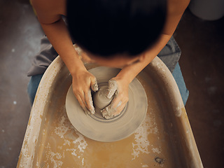 Image showing Hands, pottery and clay mold in the workshop for art, design or creative small business startup. Hand of employee artist in craft, molding or shaping with ceramics for creativity at the workplace