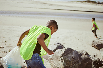 Image showing Environment, cleaning and children with plastic on beach for clean up, pollution and eco friendly volunteer. Sustainability, recycle and boy reduce waste, trash and global warming on beach sand