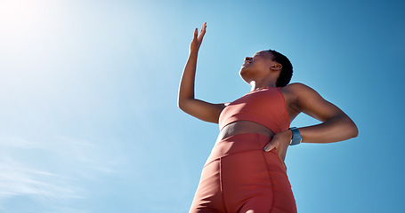 Image showing Fitness, blue sky and mockup with a sports black woman blocking the sun while running outdoor for cardio. Workout, wellness and health with a female runner or athlete covering her face from sunlight