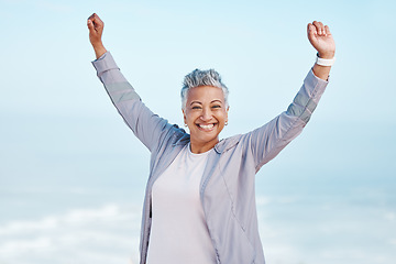 Image showing Fitness, hands in air and senior woman for exercise, fitness or workout portrait goals, success and achievement on blue sky mockup. Winner, freedom and healthy celebration of elderly runner in nature