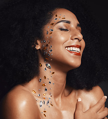 Image showing Woman face, body art jewels or diamond rhinestones on black background studio in fashion sparkle, festival accessory or creative party crystals. Happy smile, makeup beauty model or skin cosmetic gems