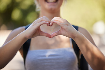 Image showing Hands, woman and heart emoji in nature while outdoor for love, freedom and support for summer travel adventure. Happy young female with hand sign and backpack for motivation, peace and wellness