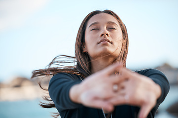 Image showing Stretching, focus and woman at the beach for fitness, running and morning cardio in Portugal. Freedom, yoga and girl with an arms warm up for exercise, training start and body health at the sea