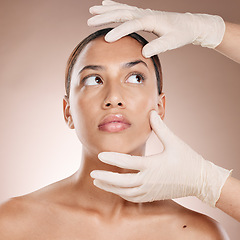 Image showing Plastic surgery, botox and hands check woman face for laser, beauty implant or cosmetic salon. Skincare consultation, facial and gloves for aesthetic change at liposuction clinic on studio background