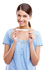 Image showing Happy, portrait and pregnant test of woman with excited face for motherhood, maternity and future baby. Happiness of girl holding pregnancy test with smile on isolated white background.