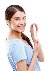 Image showing Pregnancy test, happy and portrait of a woman in a studio with good, exciting and positive news. Happiness, smile and young female model with a prenatal urine kit isolated by a white background.