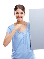 Image showing Portrait, pointing and blank sign with a woman in studio isolated on a white background holding a poster for branding. Logo, marketing and brand with a female showing mockup space for advertising