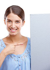 Image showing Portrait, pointing and poster with a woman in studio isolated on a white background holding a blank sign for branding. Logo, marketing and brand with a female showing mockup space for advertising