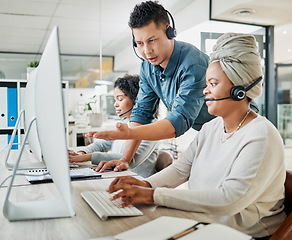 Image showing Call center, customer service and manager helping a consultant with an online consultation in the office. Contact us, crm and male telemarketing leader consulting a female agent with a ecommerce sale