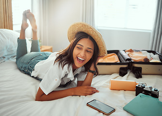 Image showing Happy, travel packing and woman on a hotel bed with suitcase ready for summer vacation. Luggage, bedroom and smile of a person relax in accommodation with clothes or happiness about traveling journey