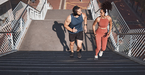 Image showing Fitness, stairs and city with a diversity couple training for sports, cardio or endurance outdoor together. Workout, health and exercise with a man and woman athlete running up a staircase from above