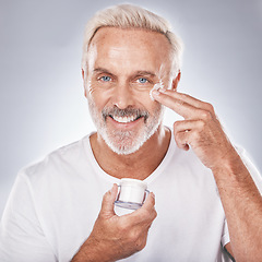 Image showing Skincare, face cream and senior man portrait on white background for beauty, wellness and dermatology. Cosmetics, grooming and elderly male with anti aging beauty products, spa treatment and facial