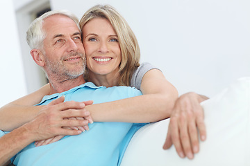 Image showing Senior couple, hug and happy portrait with love at home for trust, care and support for retirement. Commitment of man and woman in a healthy marriage and lifestyle with security on living room couch