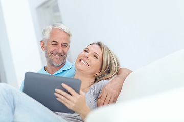 Image showing Senior, tablet and couple on a house couch on technology laughing and watching a movie on tech, Home, sofa and mature people in love with care smile about internet meme or social media scroll