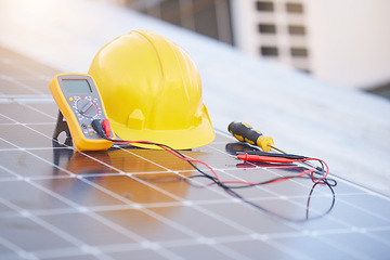 Image showing Tools, solar panels or helmet on roof for solar energy installation in a city development project. Voltmeter, Construction, renewable energy or electric engineering equipment for building maintenance