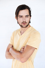 Image showing Man, vertical and thinking with casual fashion and arms crossed with isolated white background. Studio, person and adult with tshirt and beard feeling calm and relax think and standing with mockup