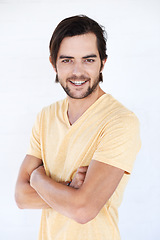 Image showing Happy, man and portrait of a model with casual tshirt and vertical white background. Isolated, arms crossed and person smiling and feeling positive with happiness alone and comfortable fashion