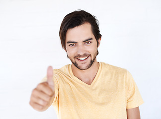 Image showing Thumbs up, winner and portrait of man in studio, white background or isolated emoji. Male model, thumb up and support of yes agreement, celebration and hand sign, vote or trust, thank you and success