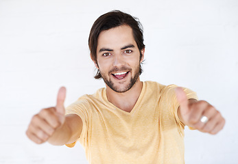 Image showing Thumbs up, success and portrait of man in white background, studio or isolated emoji. Male model, thumb up and support of yes agreement, celebration and hand sign, vote or trust, thank you and winner