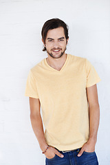 Image showing Handsome young man, smile and hands in pocket for casual fashion against white studio background. Portrait of isolated attractive male standing and smiling in happiness or profile on white background