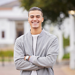 Image showing Education, smile and college with portrait of man on campus with arms crossed for learning, scholarship or knowledge. Study, future or university with student back to school for academy, exam or goal