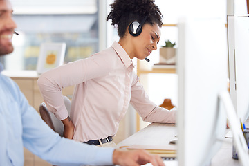 Image showing Back pain, stress or black woman in call center with a spine injury, burnout or muscle problem at office desk. Callcenter, emergency or sales agent frustrated with uncomfortable bad chair or backache
