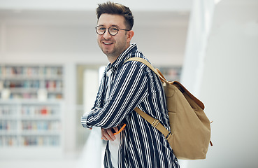 Image showing Portrait, library and student at university, college or academy for research, learning and knowledge with smile for scholarship. Study, education and creative, geek man with backpack and school goals