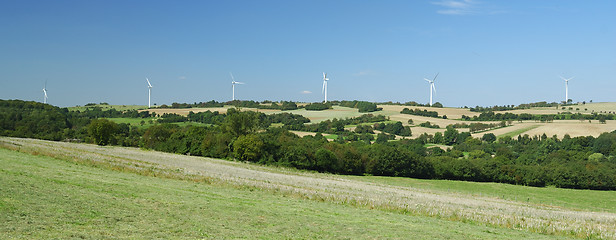 Image showing Panorama of windfarm over a hill 