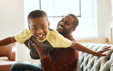 Image showing Family, portrait and father with son on the the sofa for airplane, game and bonding in their home. Love, parent and child playing in living room, smile and relax while boy enjoy fly, fun and weekend