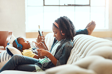 Image showing Phone, family and brother sister relax on a sofa, online and home entertainment while sitting in a lounge. Internet, siblings and girl with boy on a couch, online and entertainment in a living room