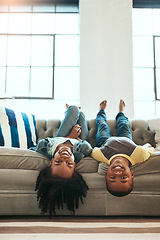 Image showing Black children, siblings and relax on living room sofa lying upside down with smile for fun time together at home. Happy African American kids relaxing, playing and smiling on couch at the house