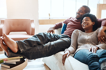 Image showing Couple, relax and watching tv on a sofa, happy and smile while bonding in their home together. Television, resting and black woman with man on a sofa, resting and having fun in the living room