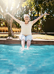 Image showing Senior woman, smile and feet in swimming pool in relax for summer vacation, swim or holiday joy in the outdoors. Happy elderly female with arms stretched out in happiness for relaxation by water pool