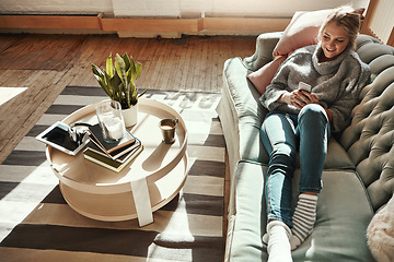 Image showing Relax, home sofa and woman on a phone in a living room calm on a social media scroll. House couch, lounge and person relax on a mobile online on wifi looking happy from streaming web content