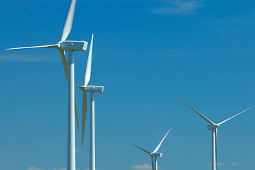 Image showing four windturbines on blue sky