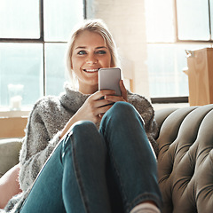 Image showing Smile, woman and phone on a home sofa with lens flare and happiness in the sun on wifi. Mobile, social media scroll and mobile phone internet of a person on a house couch in a living room happy