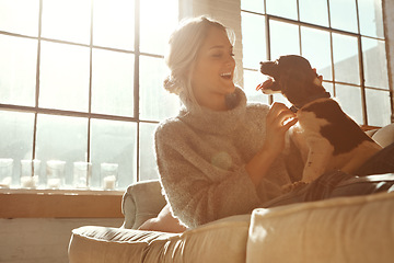 Image showing Woman, dog and on couch in living room, happiness and sunshine with girl, happiness and bonding at home. Female, lady and pet on sofa in lounge, relax and weekend on break, happy or sunlight in house