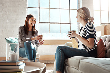 Image showing Woman, friends and smile for coffee, conversation or social catch up relaxing together on living room sofa at home. Happy women enjoying tea time, chatting or gossip with drink in apartment on couch
