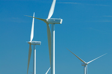 Image showing three windturbines on blue sky