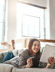 Image showing Digital tablet, credit card and woman on a sofa for online shopping, ecommerce and payment while relaxing. Girl, couch and online banking from app, purchase and booking online in a living room