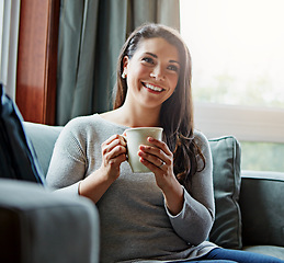 Image showing Coffee, thinking and relax with a woman in her home, sitting on a sofa in the living room feeling happy. Idea, tea and lifestyle with an attractive young female relaxing on a couch in her lounge