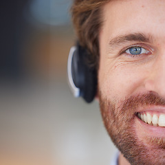 Image showing Call center man, closeup and smile in portrait for customer service, happy and focus with headphones. Customer support, crm expert and happiness in zoom of face, eye and telemarketing job in Orlando